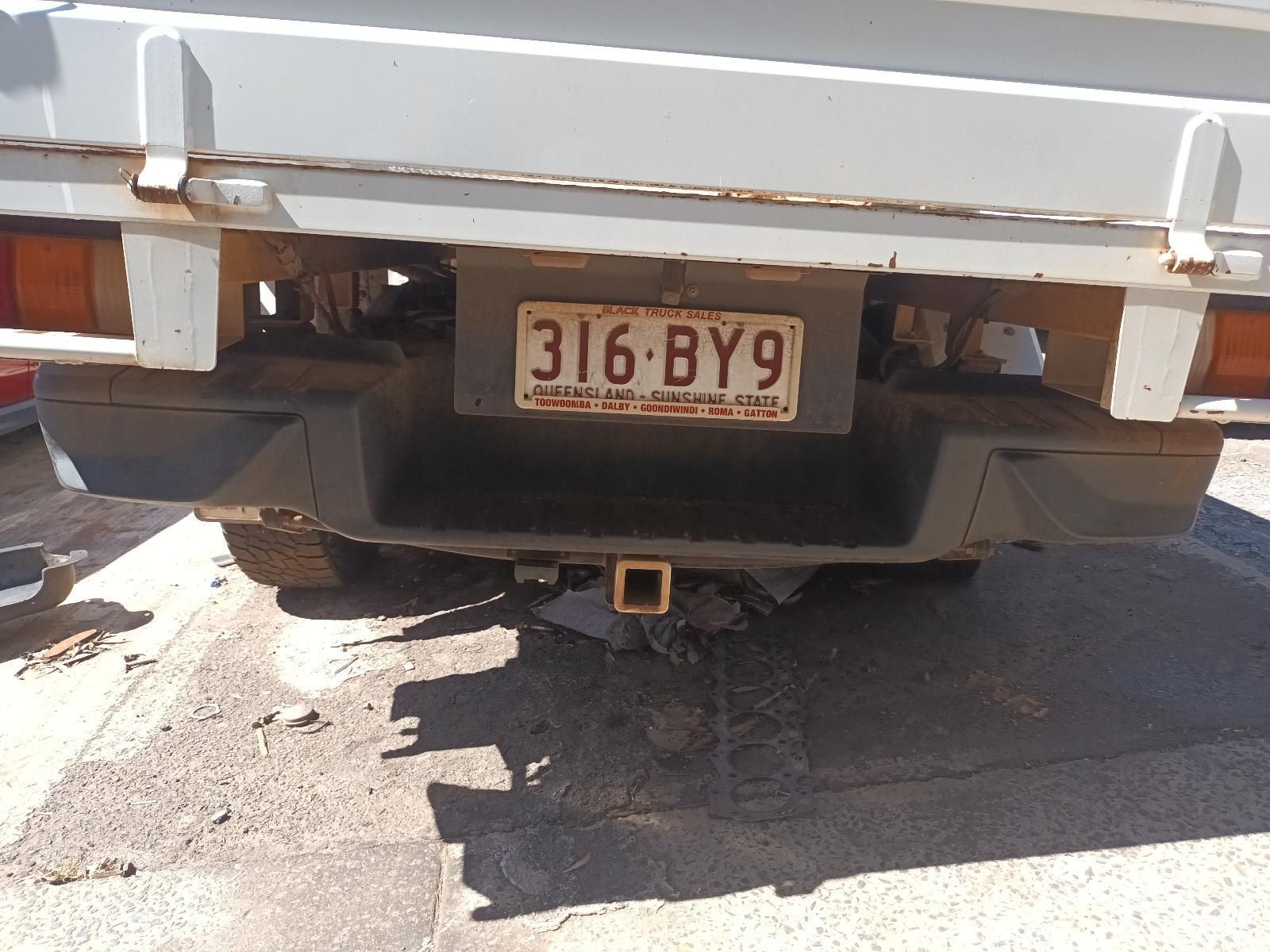 A White Truck with a License Plate That Says 316 BY9 — South West 4WD Wreckers in Harristown, QLD