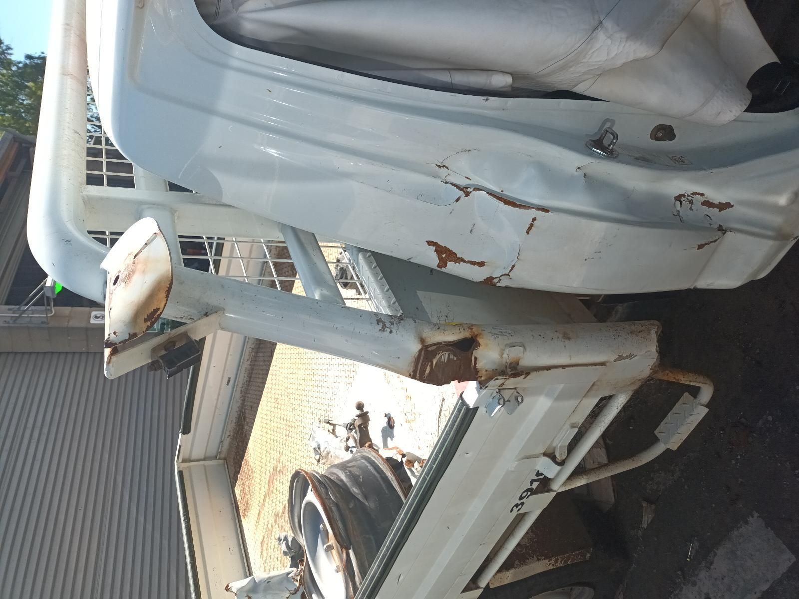 A White Car with a Broken Bumper is Parked in Front of a House — South West 4WD Wreckers in Harristown, QLD