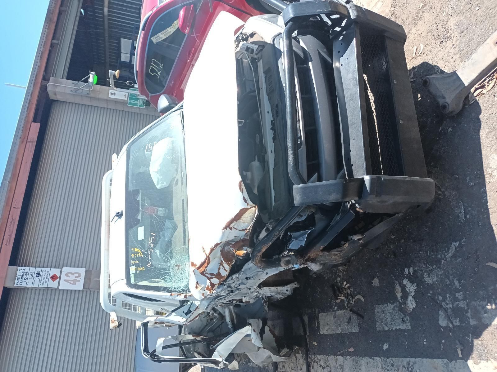A Wrecked Truck is Sitting in Front of a Building — South West 4WD Wreckers in Harristown, QLD