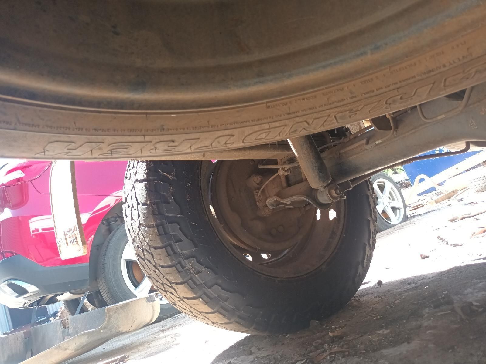 A Close Up of a Tire on a Car with a Red Car in the Background — South West 4WD Wreckers in Harristown, QLD