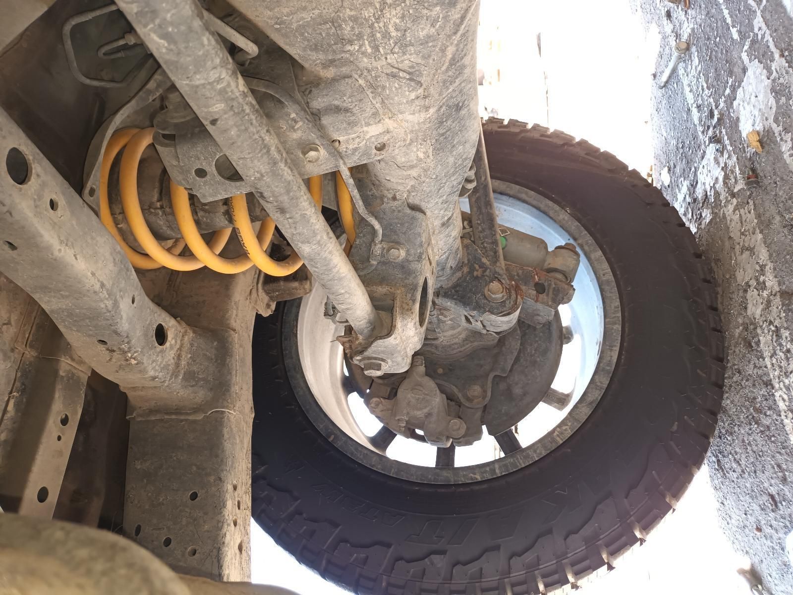 A Close Up of the Underside of a Car with a Tire on It — South West 4WD Wreckers In Brisbane, QLD