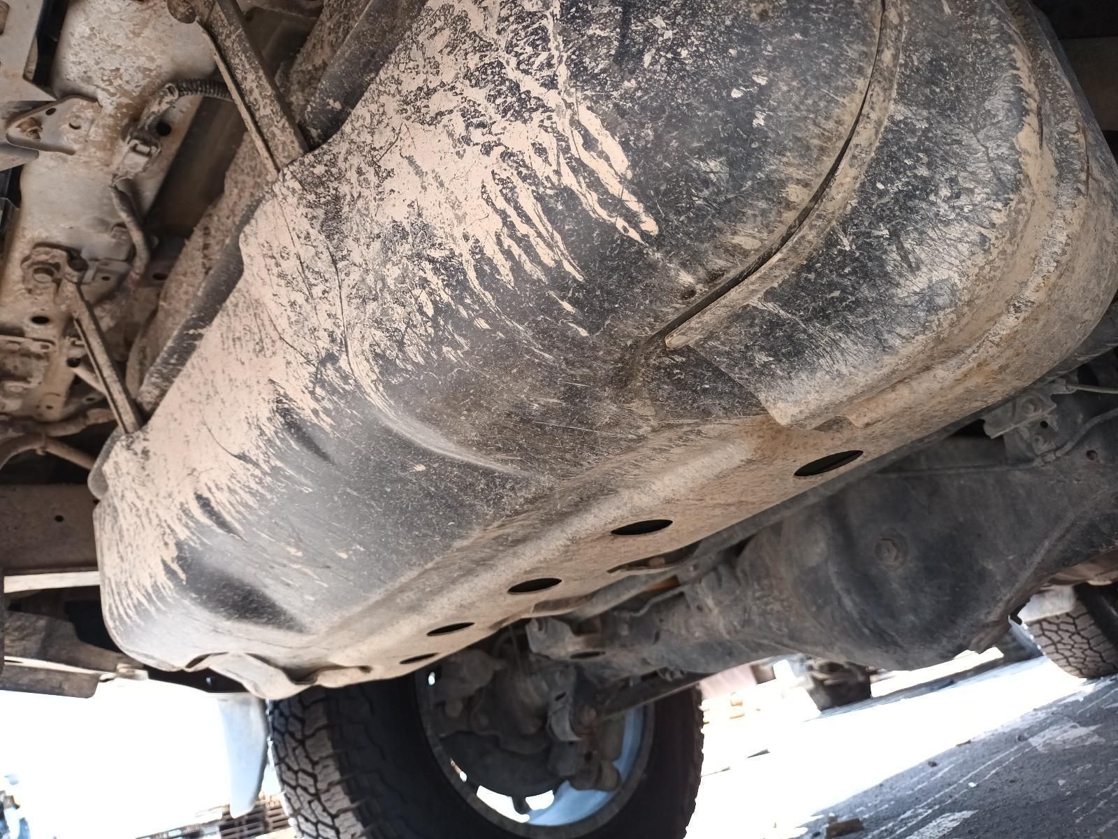 The Underside of a Car with a Fuel Tank Covered in Dirt — South West 4WD Wreckers In Brisbane, QLD