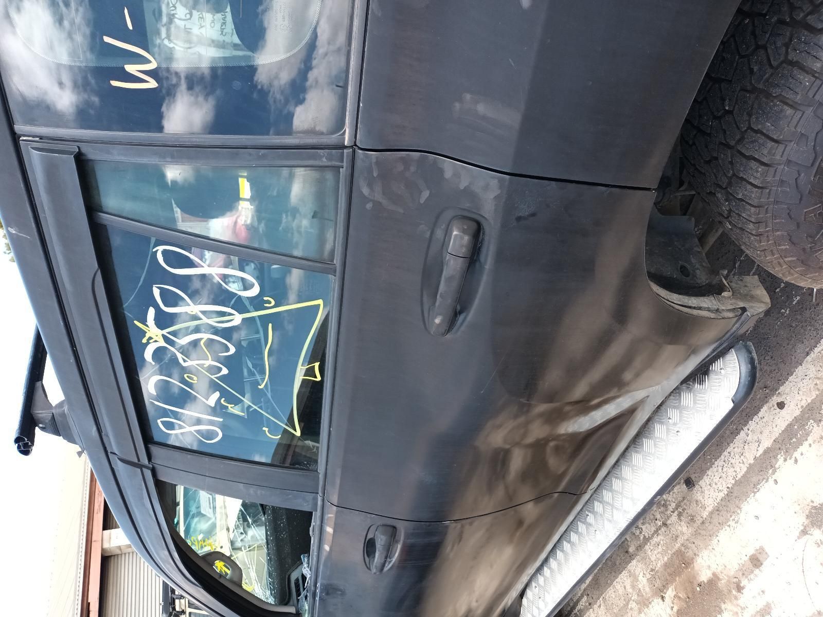 A Black Car is Parked on the Side of the Road — South West 4WD Wreckers In Brisbane, QLD