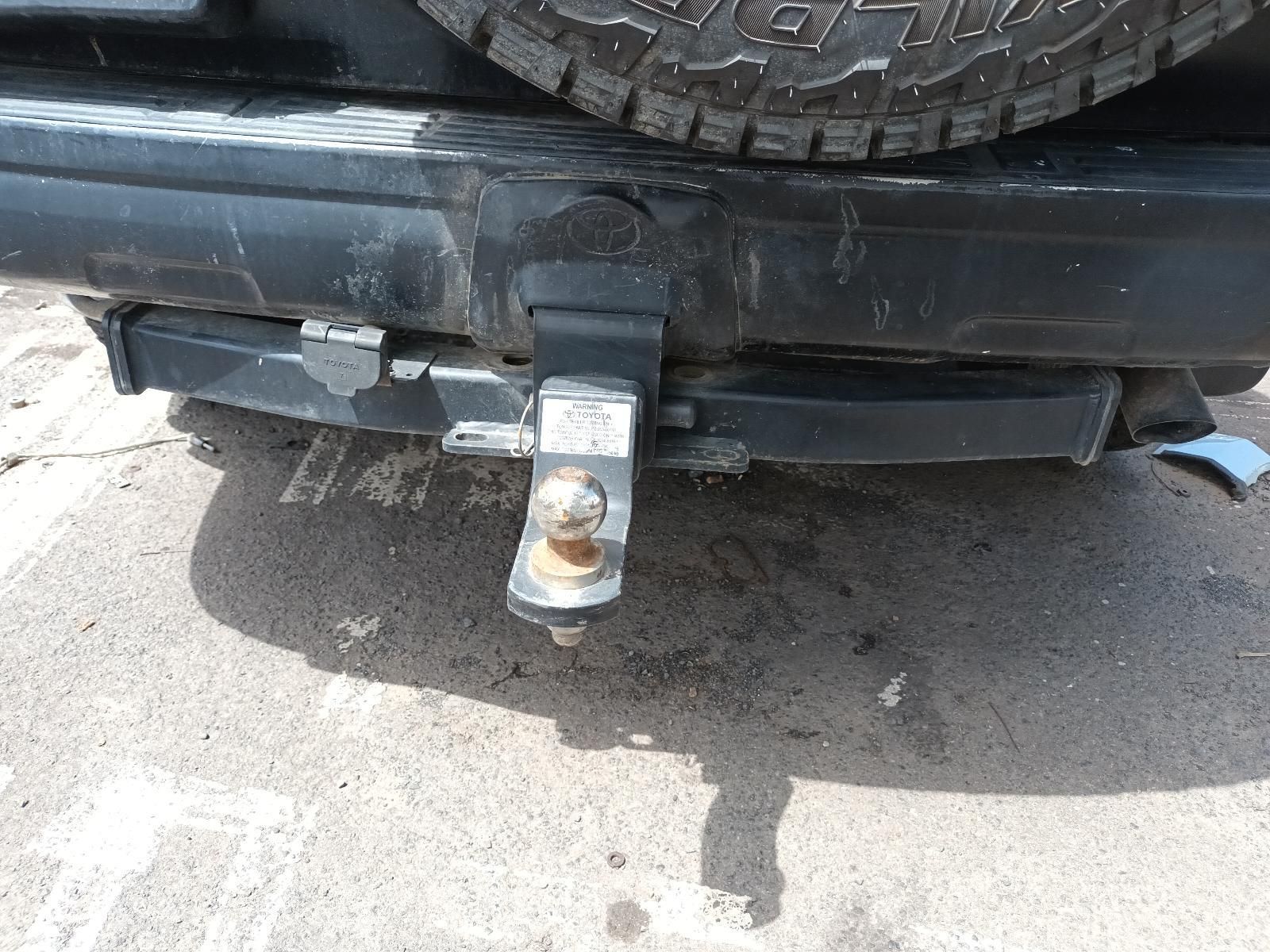 A Black Car with a Trailer Hitch Attached to the Back Bumper — South West 4WD Wreckers In Brisbane, QLD