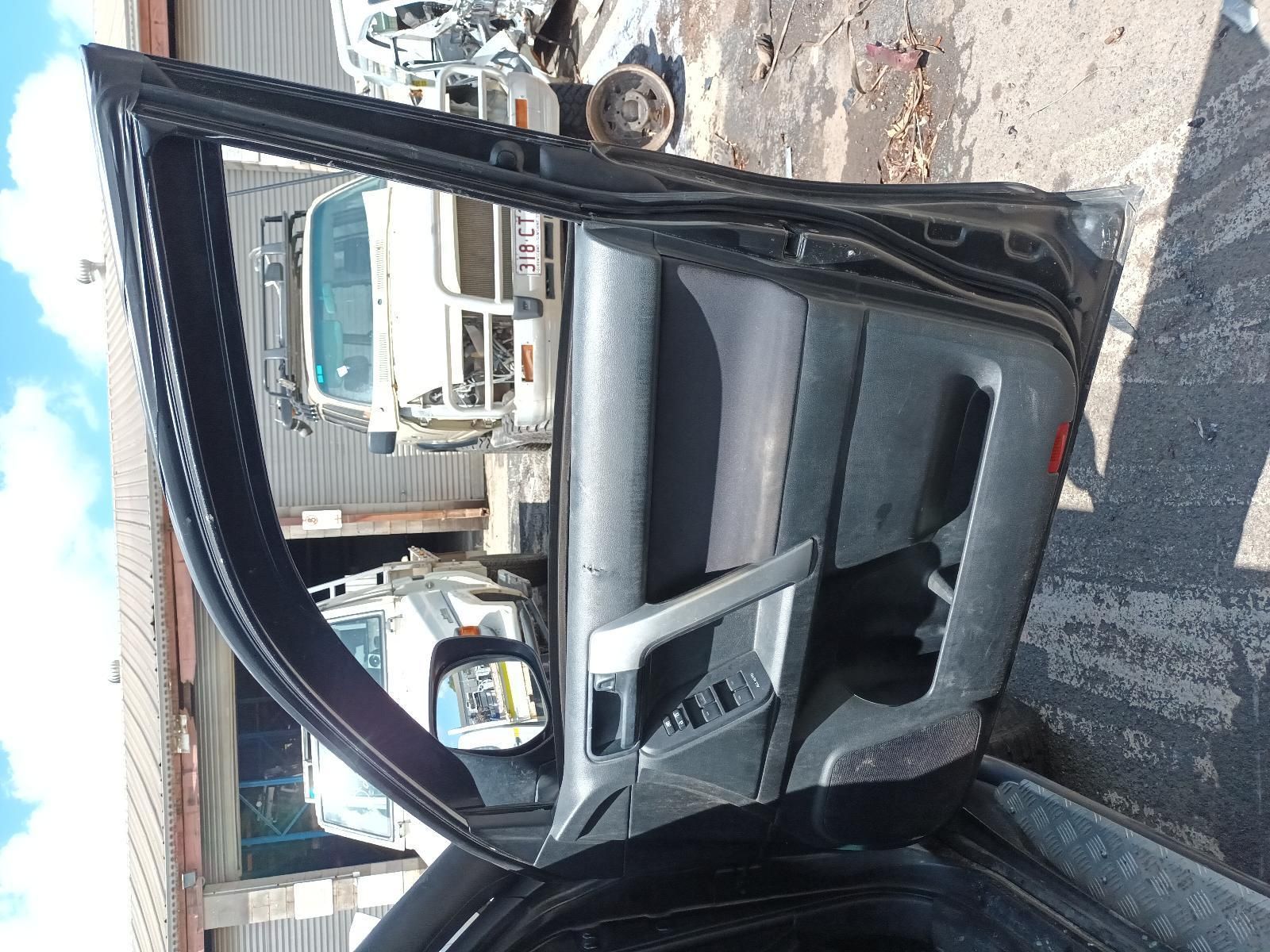 A Black Car with the Door Open is Parked in a Garage— South West 4WD Wreckers In Brisbane, QLD