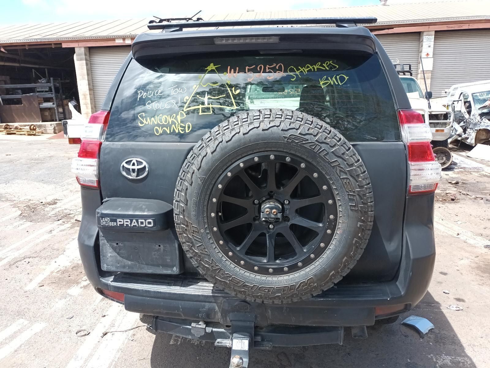 A Black Toyota Prado with a Spare Tire is Parked in a Parking Lot — South West 4WD Wreckers In Brisbane, QLD