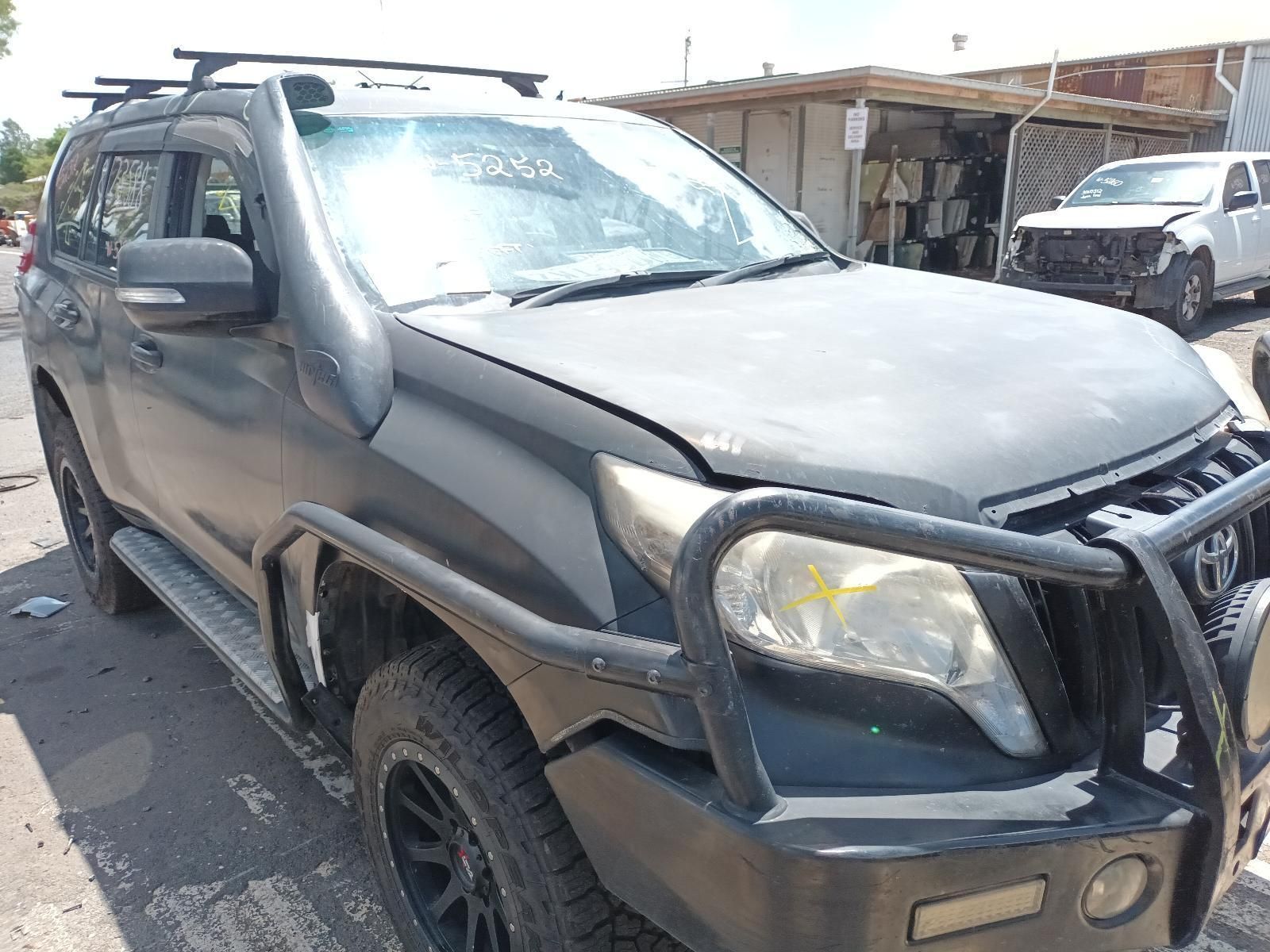 A Black Toyota Land Cruiser is Parked on the Side of the Road — South West 4WD Wreckers In Brisbane, QLD