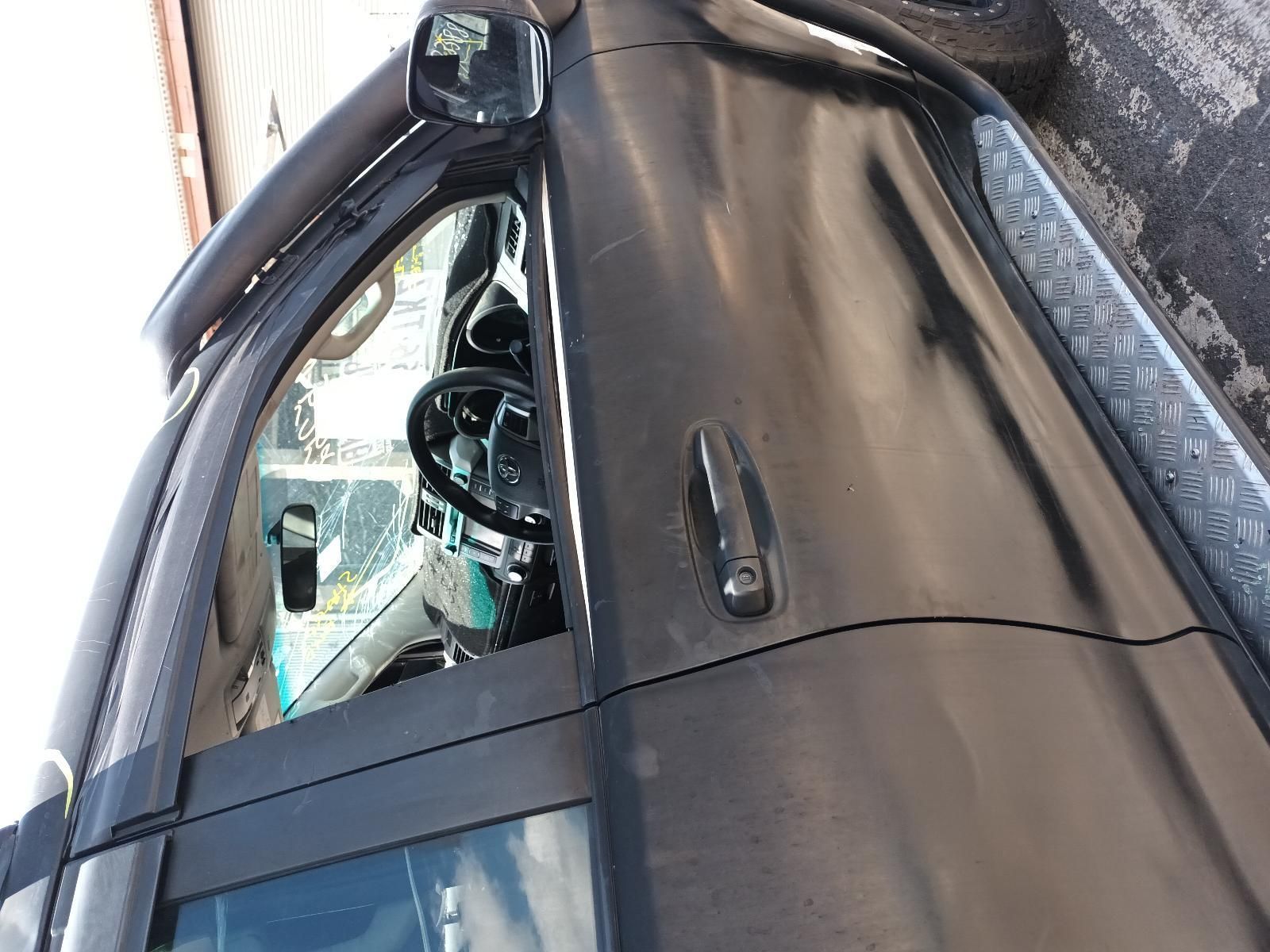 A Black Car is Parked on the Side of the Road — South West 4WD Wreckers In Brisbane, QLD