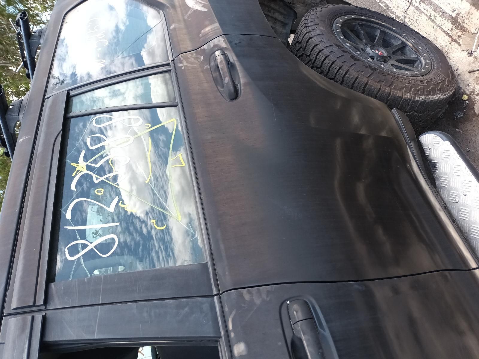 A Black Car is Parked on the Side of the Road — South West 4WD Wreckers In Brisbane, QLD