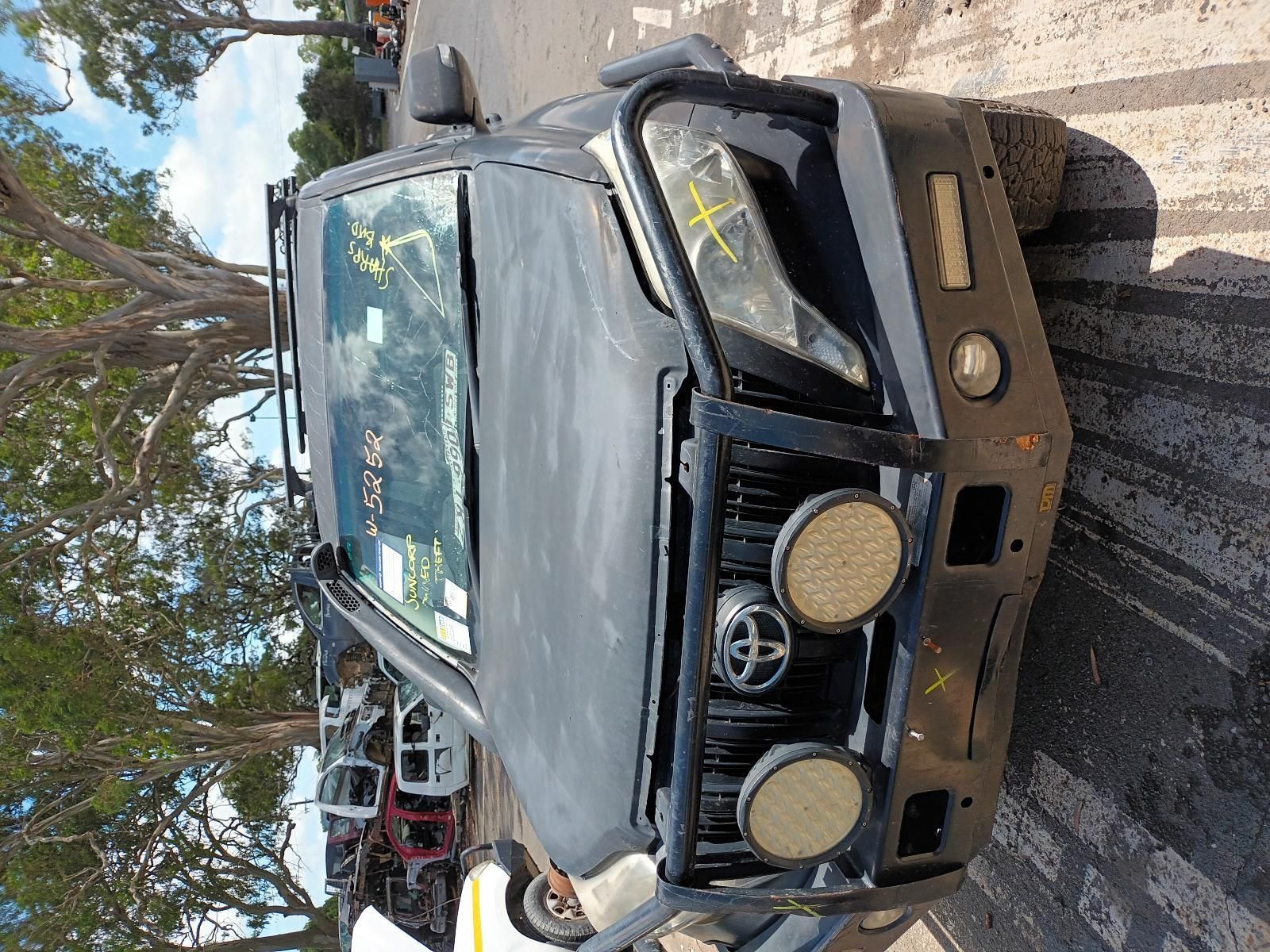 A Black Truck is Parked on the Side of the Road — South West 4WD Wreckers In Brisbane, QLD