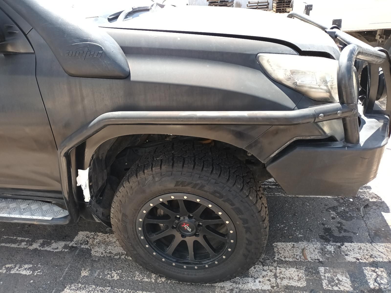 A Black Truck is Parked on the Side of the Road — South West 4WD Wreckers In Brisbane, QLD