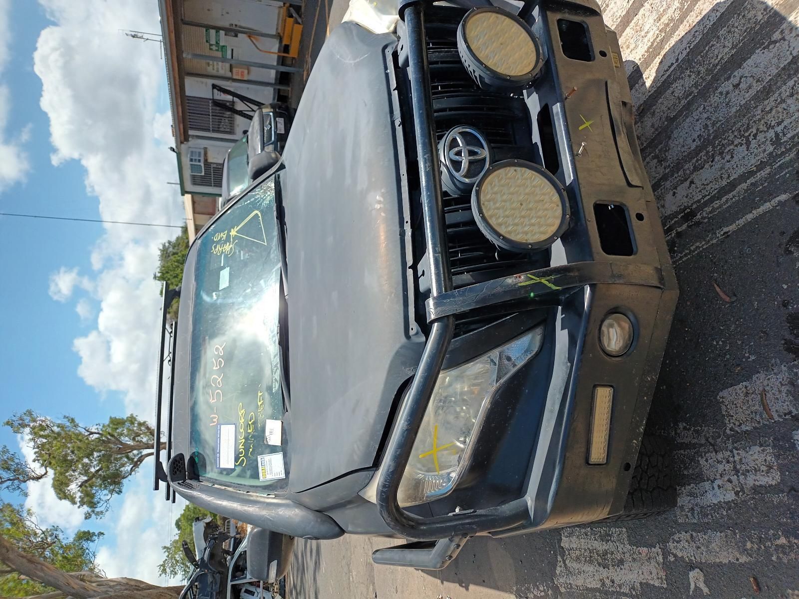A Toyota Land Cruiser is Parked on the Side of the Road — South West 4WD Wreckers In Brisbane, QLD