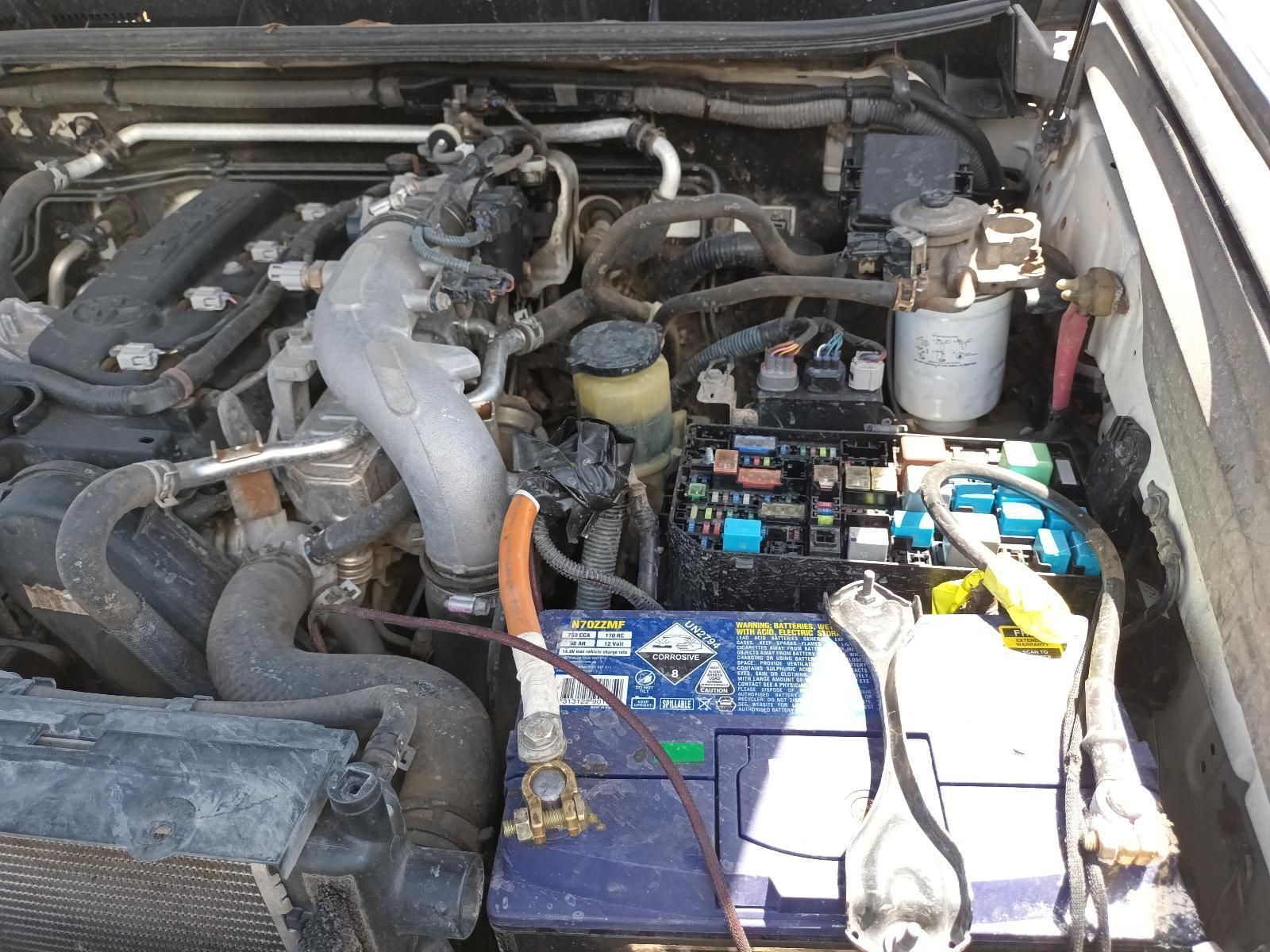 A Close Up of the Engine of a Car with a Blue Battery— South West 4WD Wreckers In Brisbane, QLD