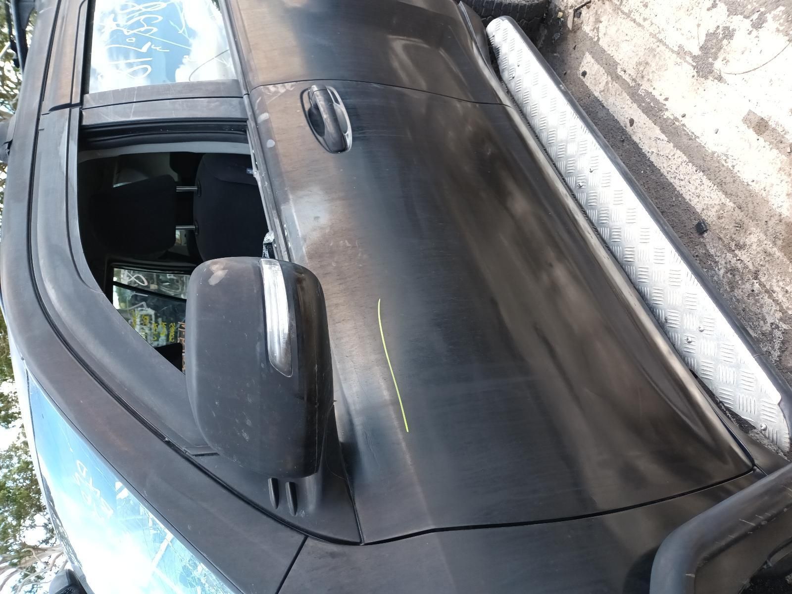 A Black Car is Parked on the Side of the Road — South West 4WD Wreckers In Brisbane, QLD