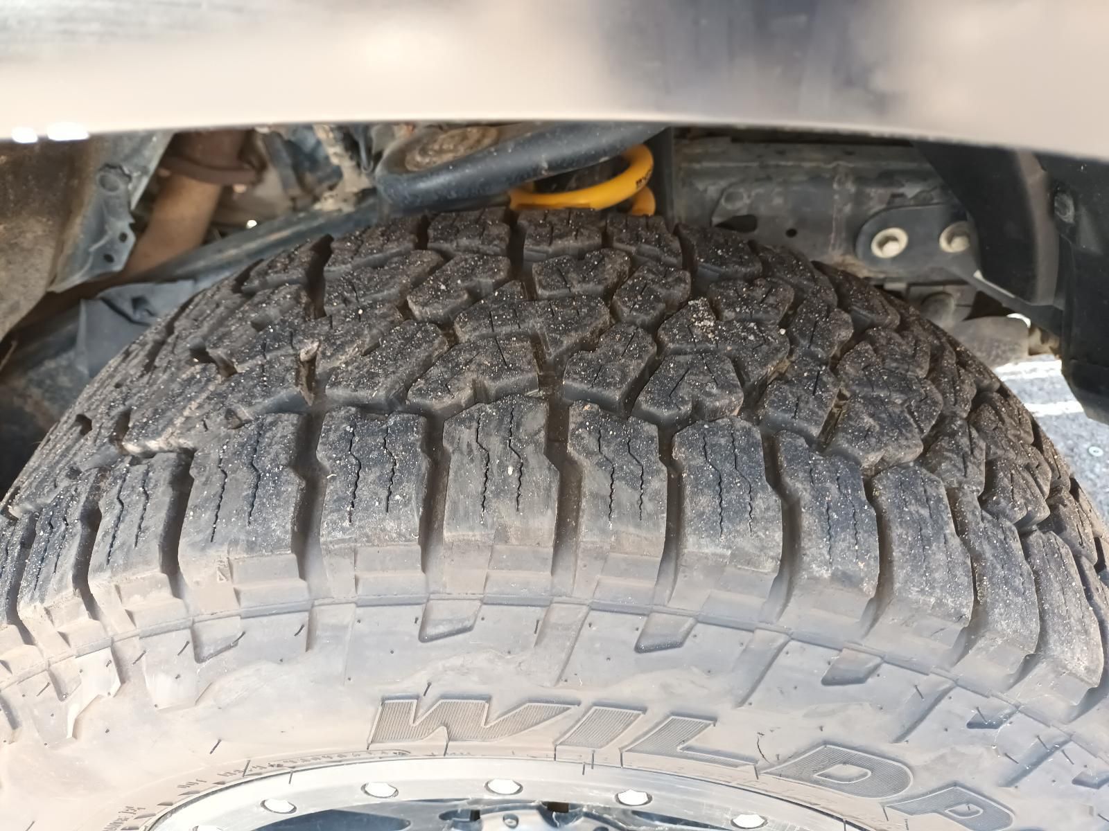 A Close Up of a Tire on a Car with a Yellow Shock Absorber — South West 4WD Wreckers In Brisbane, QLD