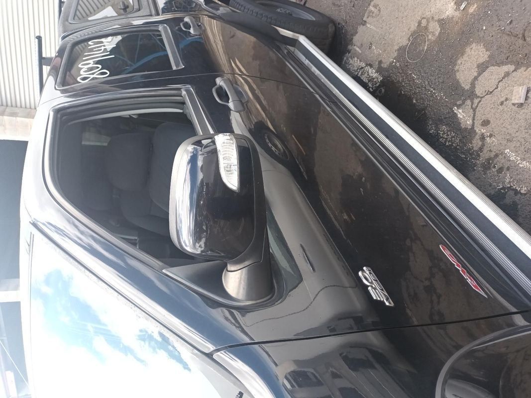 A Black Car with the Door Open is Parked on the Side of the Road — South West 4WD Wreckers In Brisbane, QLD