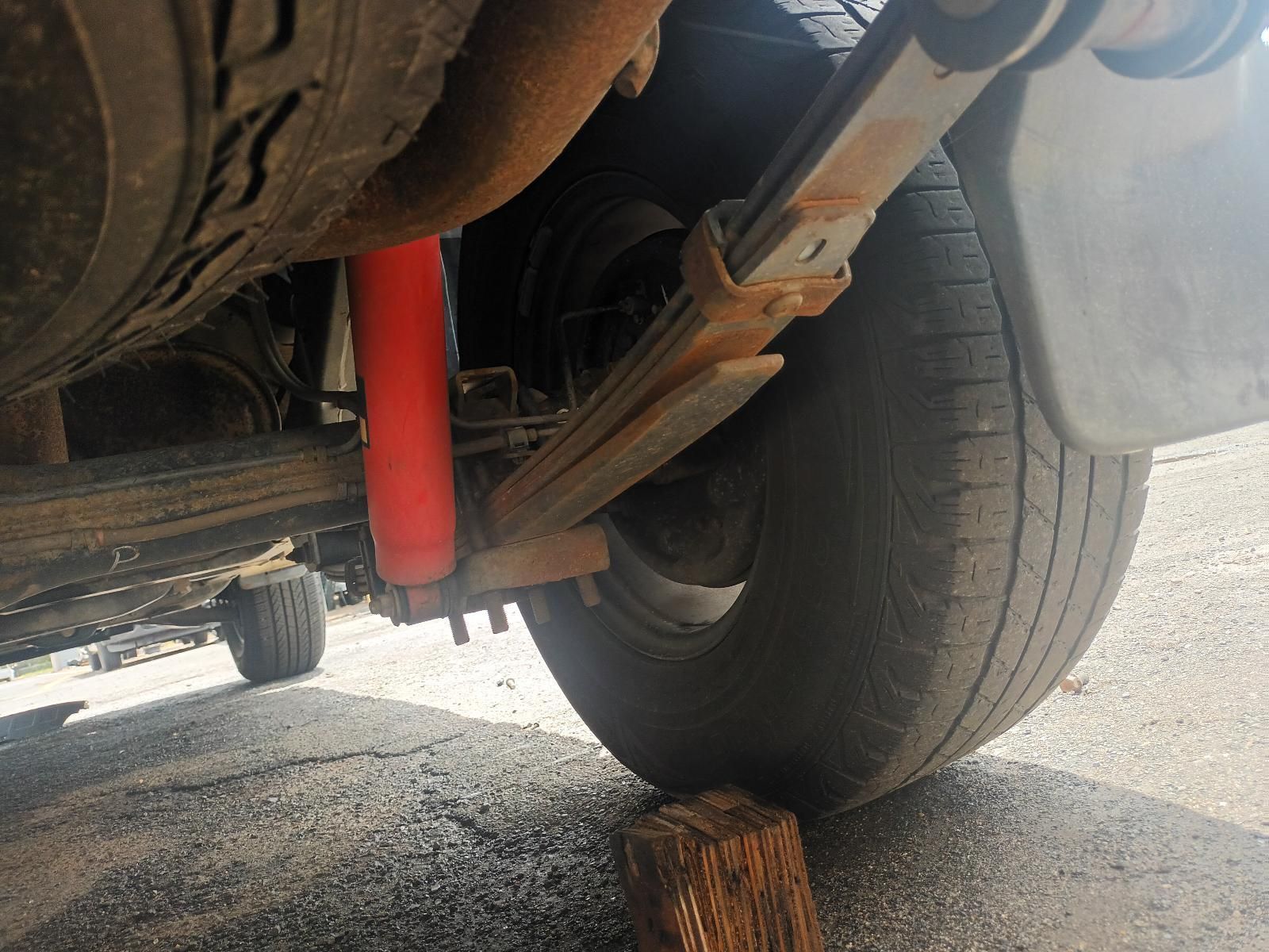 A Car with a Red Shock Absorber and a Black Tire — South West 4WD Wreckers In Brisbane, QLD