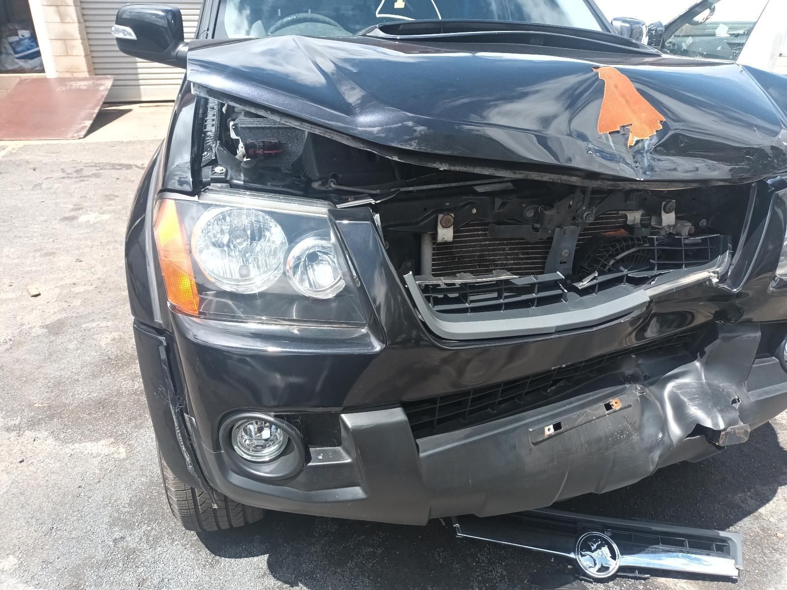 A Black Car with a Damaged Front End is Parked in a Parking Lot — South West 4WD Wreckers In Brisbane, QLD