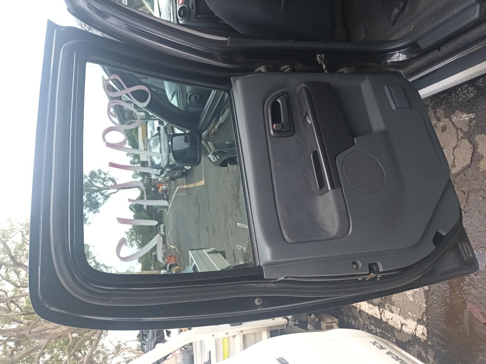A Black Car with the Door Open is Parked in a Parking Lot — South West 4WD Wreckers In Brisbane, QLD