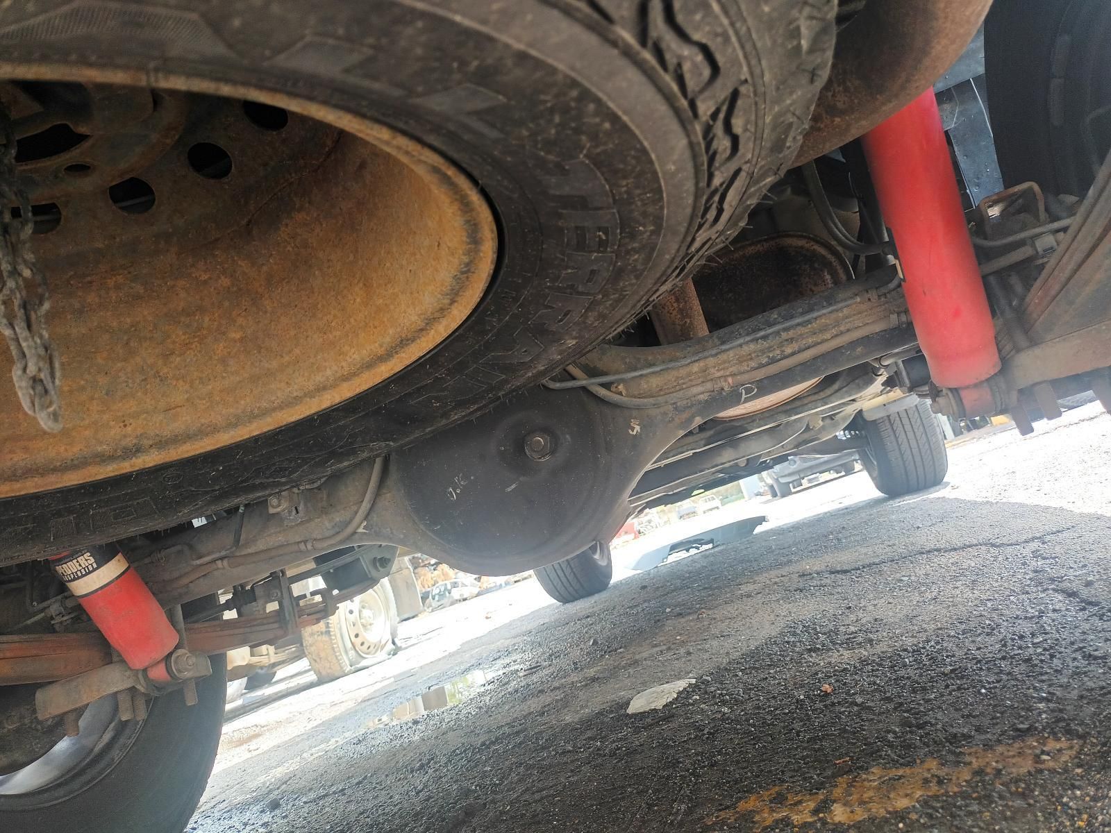 A Close Up of the Underside of a Car with a Tire and Shocks — South West 4WD Wreckers In Brisbane, QLD
