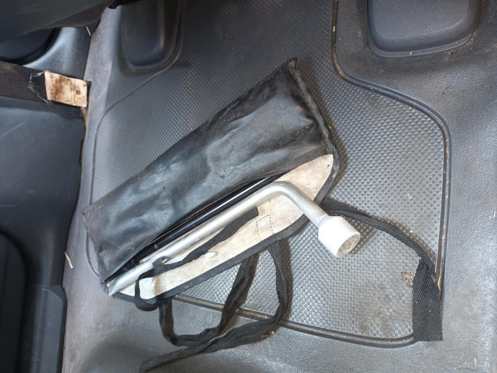 A Tire Wrench is Sitting in a Black Bag on the Floor of a Car — South West 4WD Wreckers In Brisbane, QLD