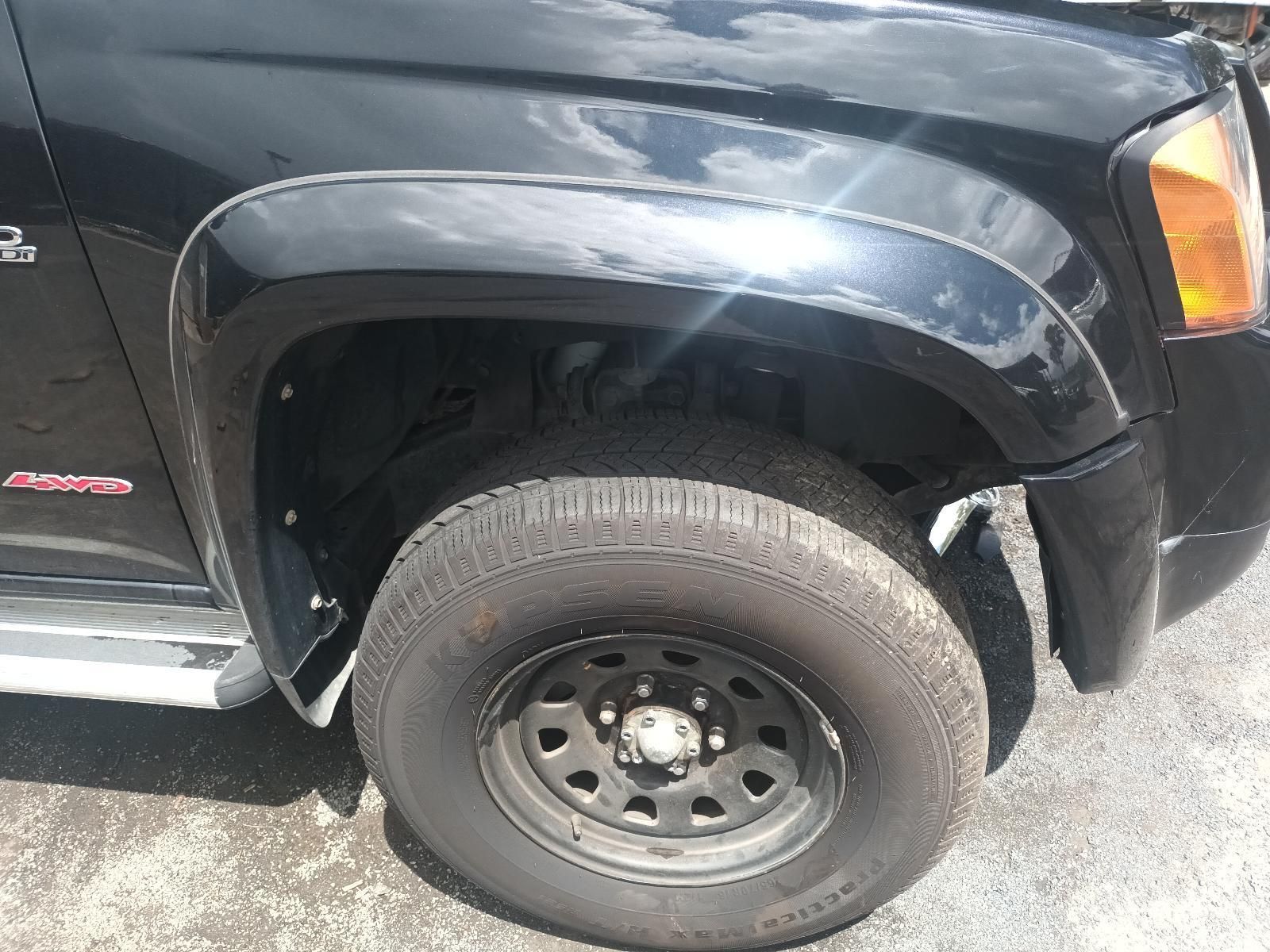 A Black Truck is Parked on the Side of the Road — South West 4WD Wreckers In Brisbane, QLD