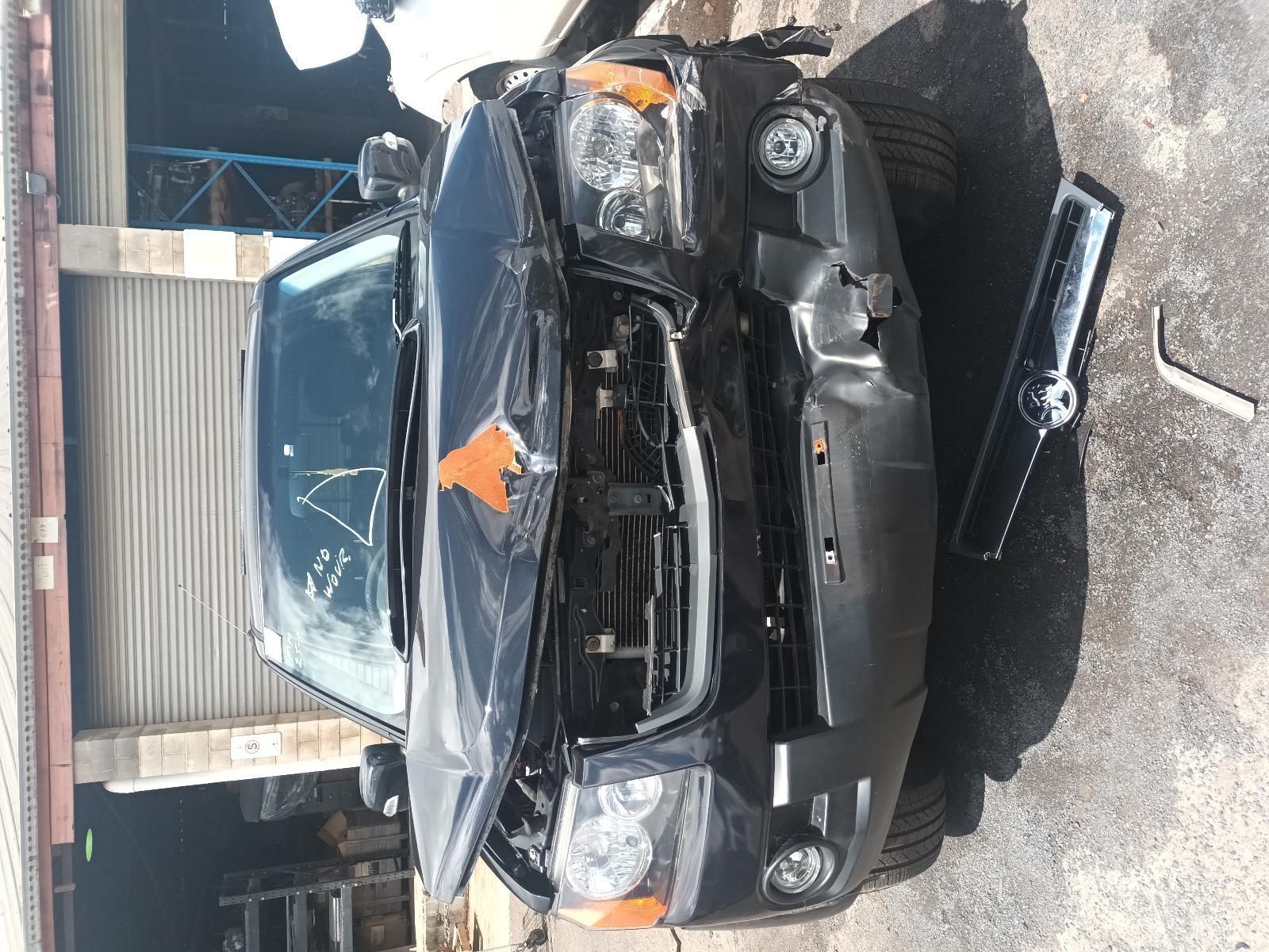A Black Car with the Hood Open is Sitting in Front of a Garage — South West 4WD Wreckers In Brisbane, QLD