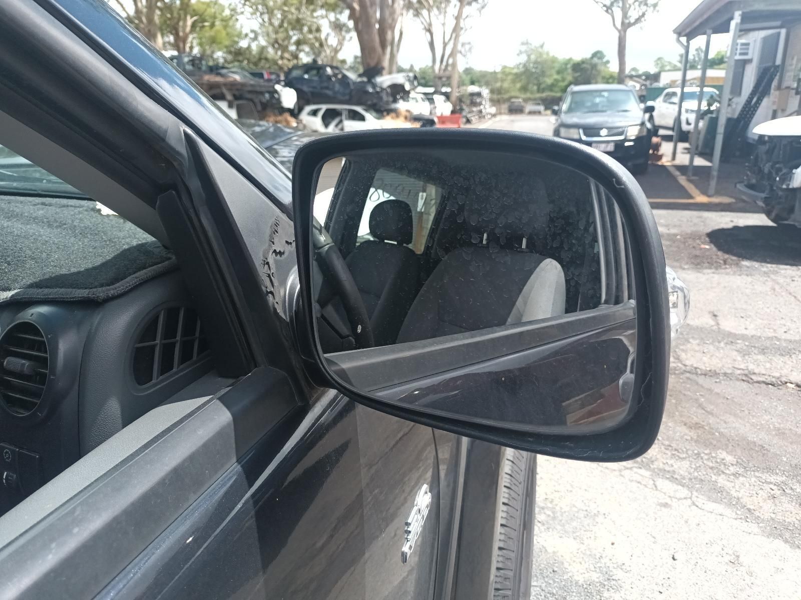 A Car is Parked in a Parking Lot and the Side View Mirror is Visible — South West 4WD Wreckers In Brisbane, QLD