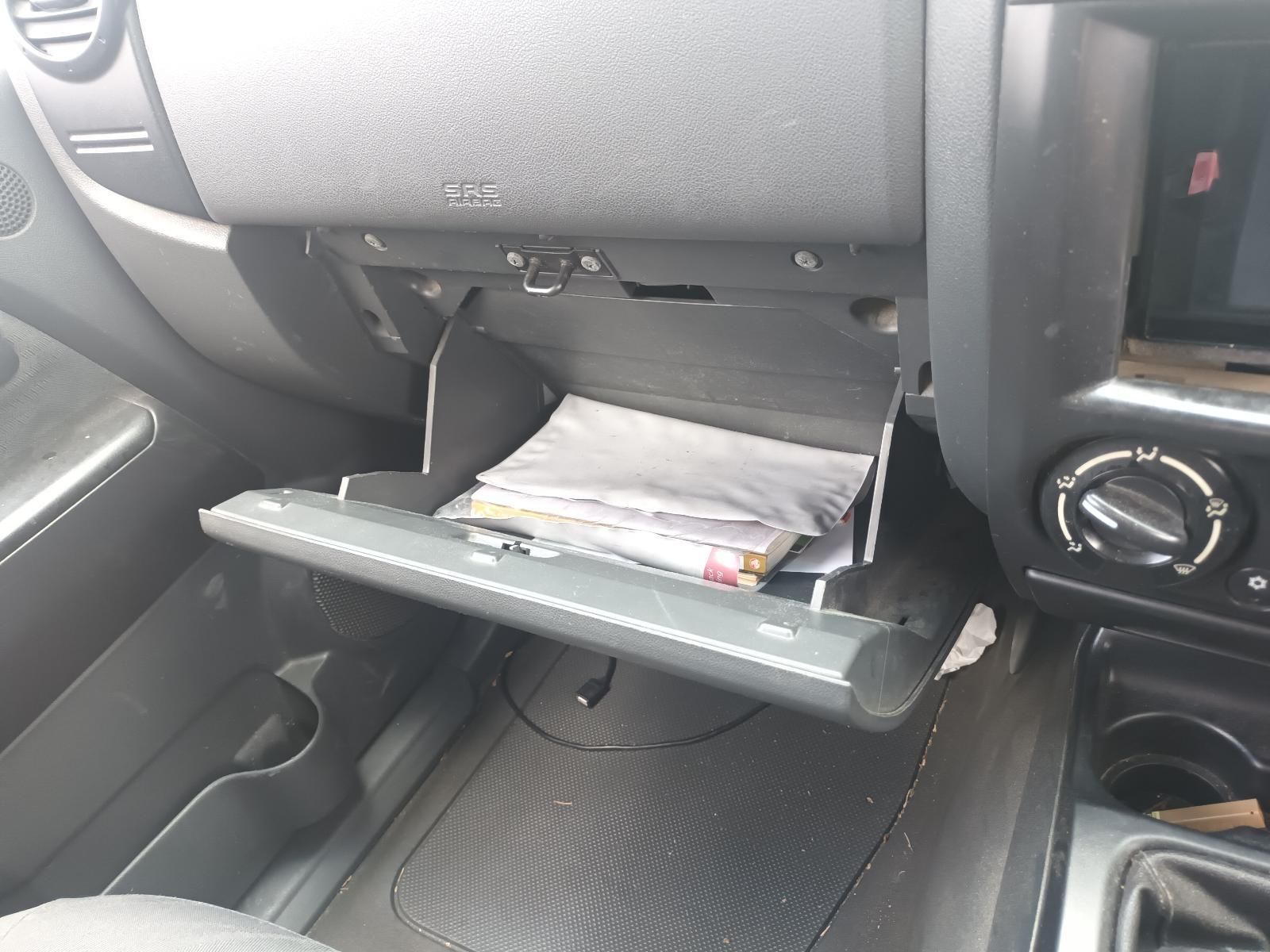 The Glove Box of a Car is Open and Filled with Papers — South West 4WD Wreckers In Brisbane, QLD