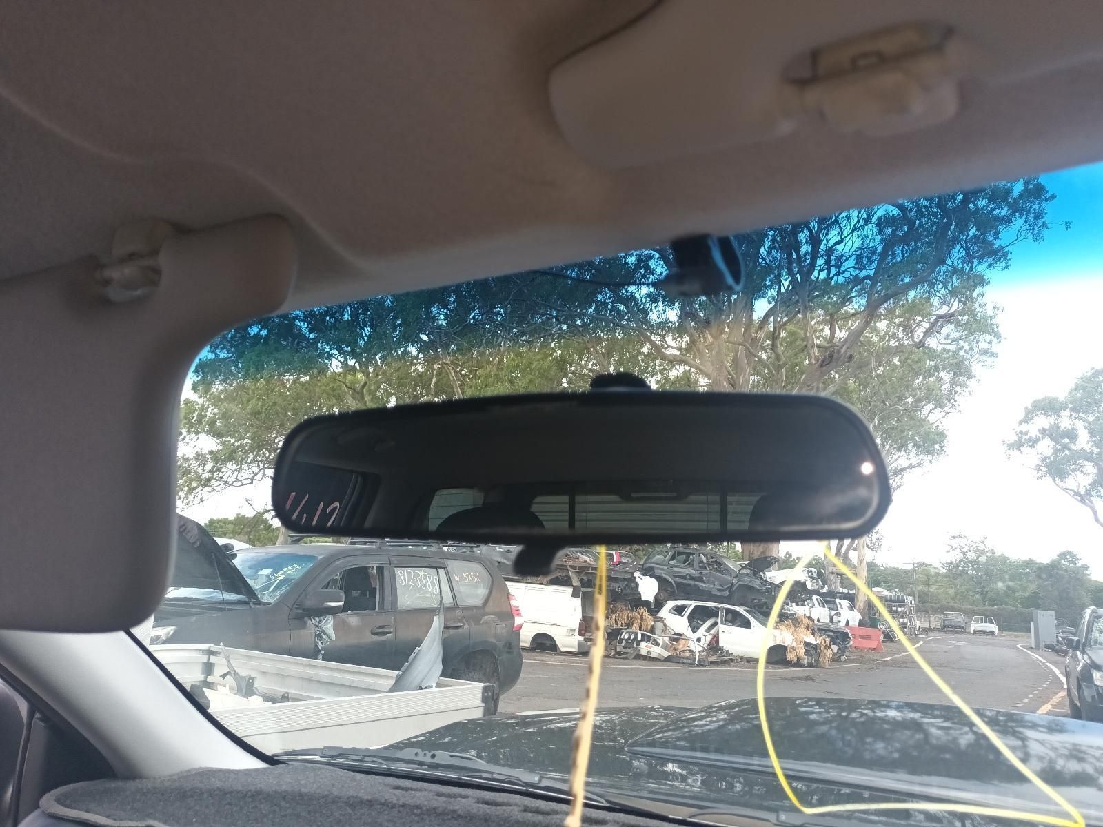 A Rear View Mirror in a Car Shows a Parking Lot — South West 4WD Wreckers In Brisbane, QLD
