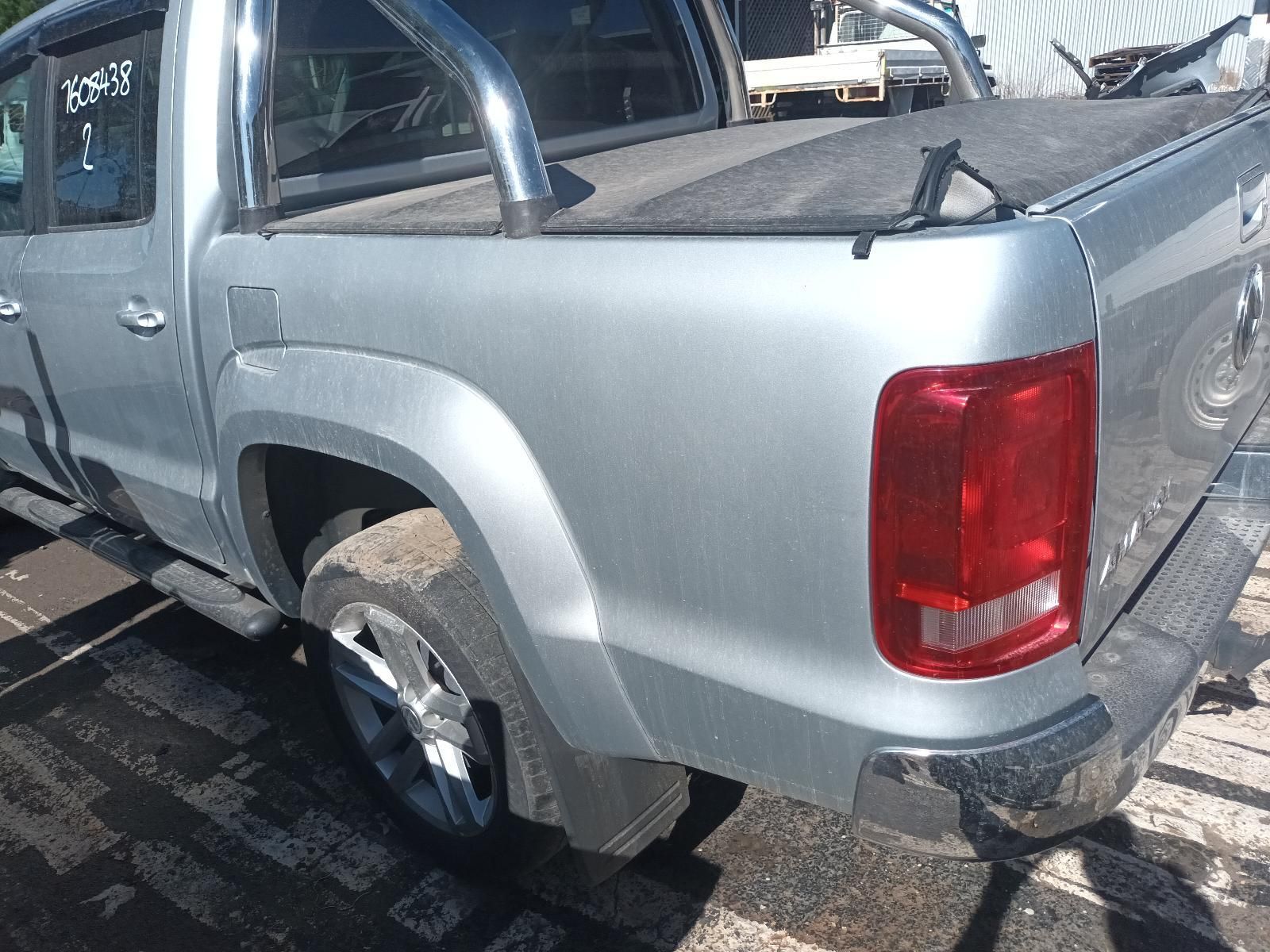 A Silver Truck with a Red Tail Light is Parked in a Parking Lot — South West 4WD Wreckers in Harristown, QLD