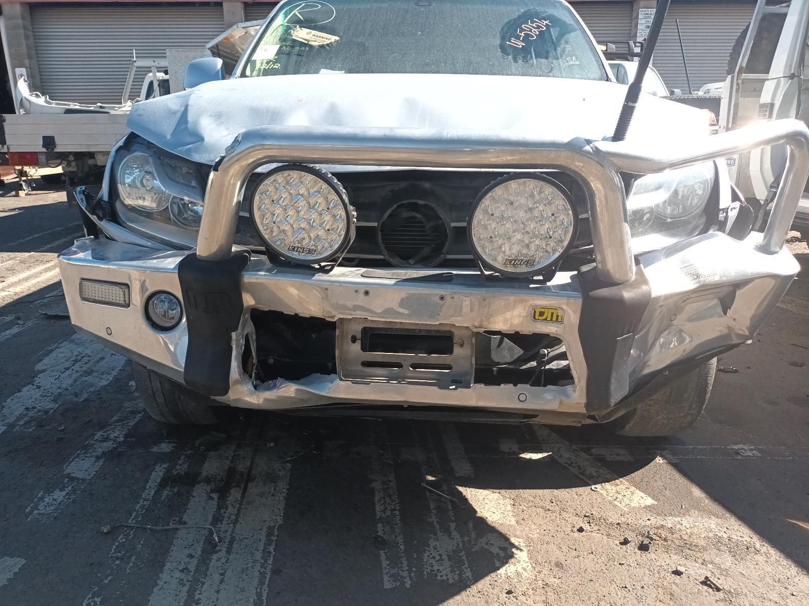 A Silver Truck with a Bumper and Lights on It is Parked on the Side of the Road — South West 4WD Wreckers in Harristown, QLD