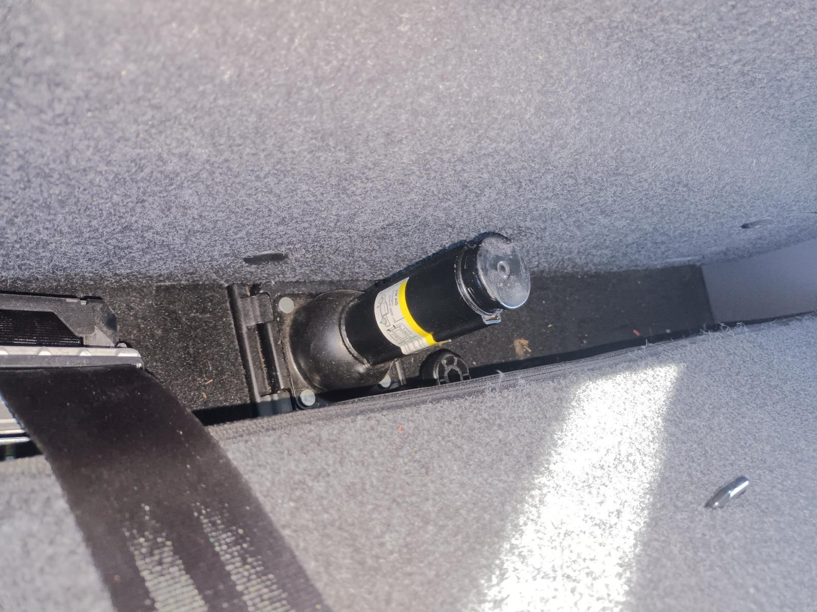 A Black Bottle with a Yellow Label is Sitting on a Gray Surface — South West 4WD Wreckers in Harristown, QLD