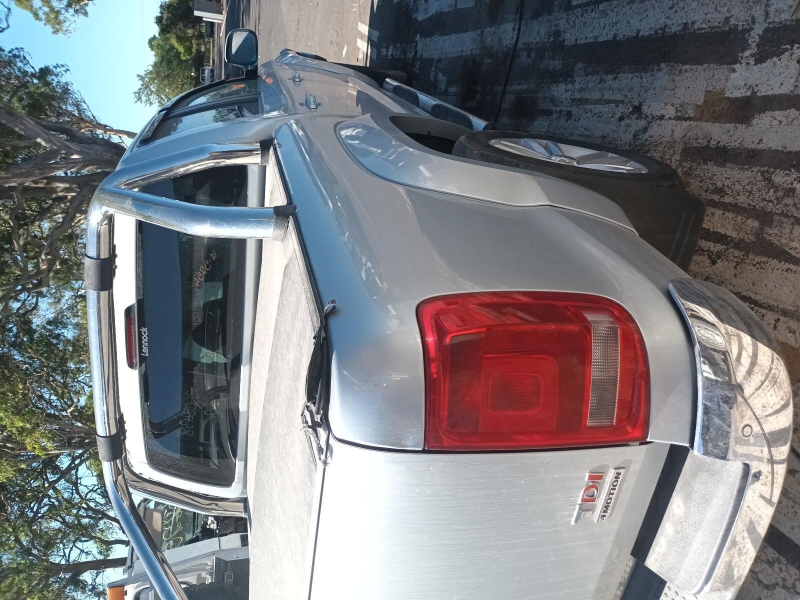 A Silver Truck with a Red Tail Light is Parked on the Side of the Road — South West 4WD Wreckers in Harristown, QLD