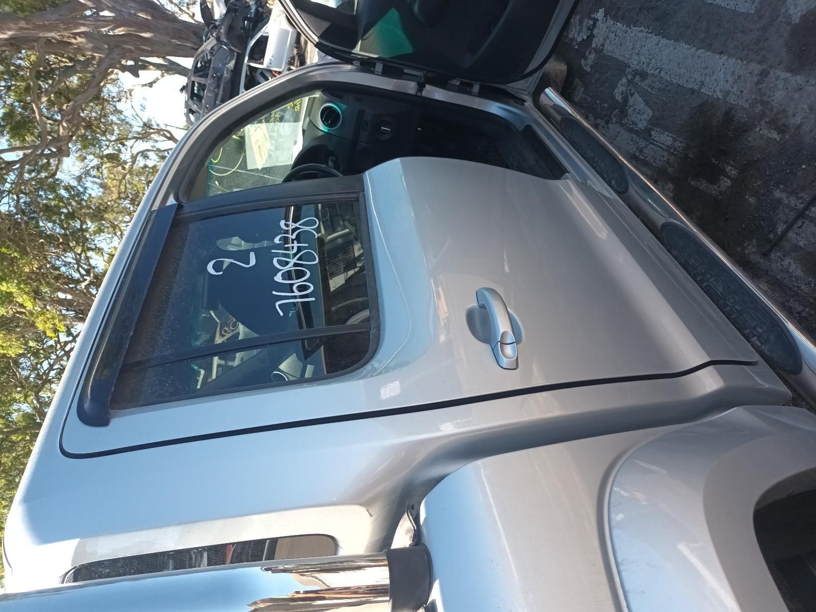 A Silver Truck is Parked in a Parking Lot with the Door Open — South West 4WD Wreckers in Harristown, QLD