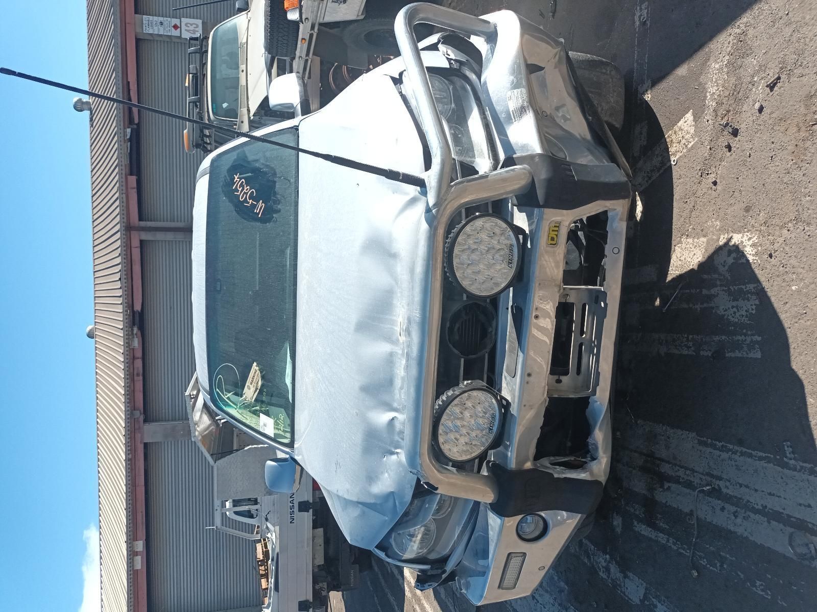 A Damaged Truck is Parked in Front of a Building — South West 4WD Wreckers in Harristown, QLD
