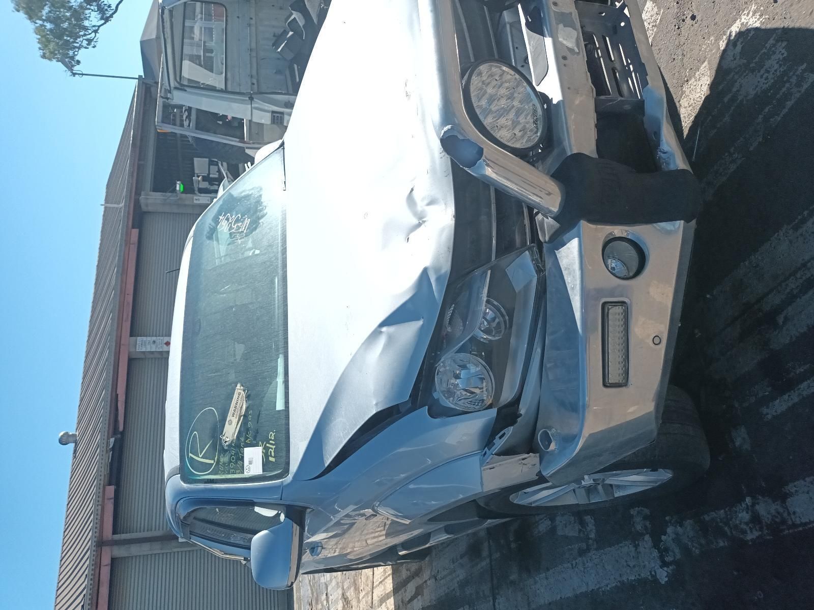 A Damaged Car is Parked in Front of a Building — South West 4WD Wreckers in Harristown, QLD