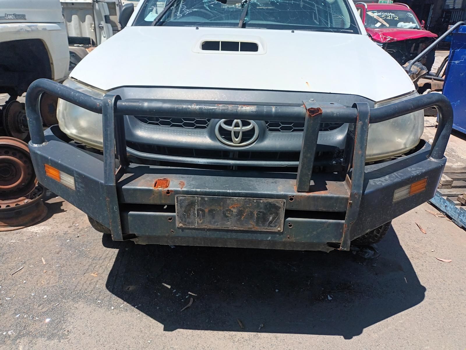 A White Toyota Truck with a Black Bumper is Parked in a Lot — South West 4WD Wreckers in Harristown, QLD