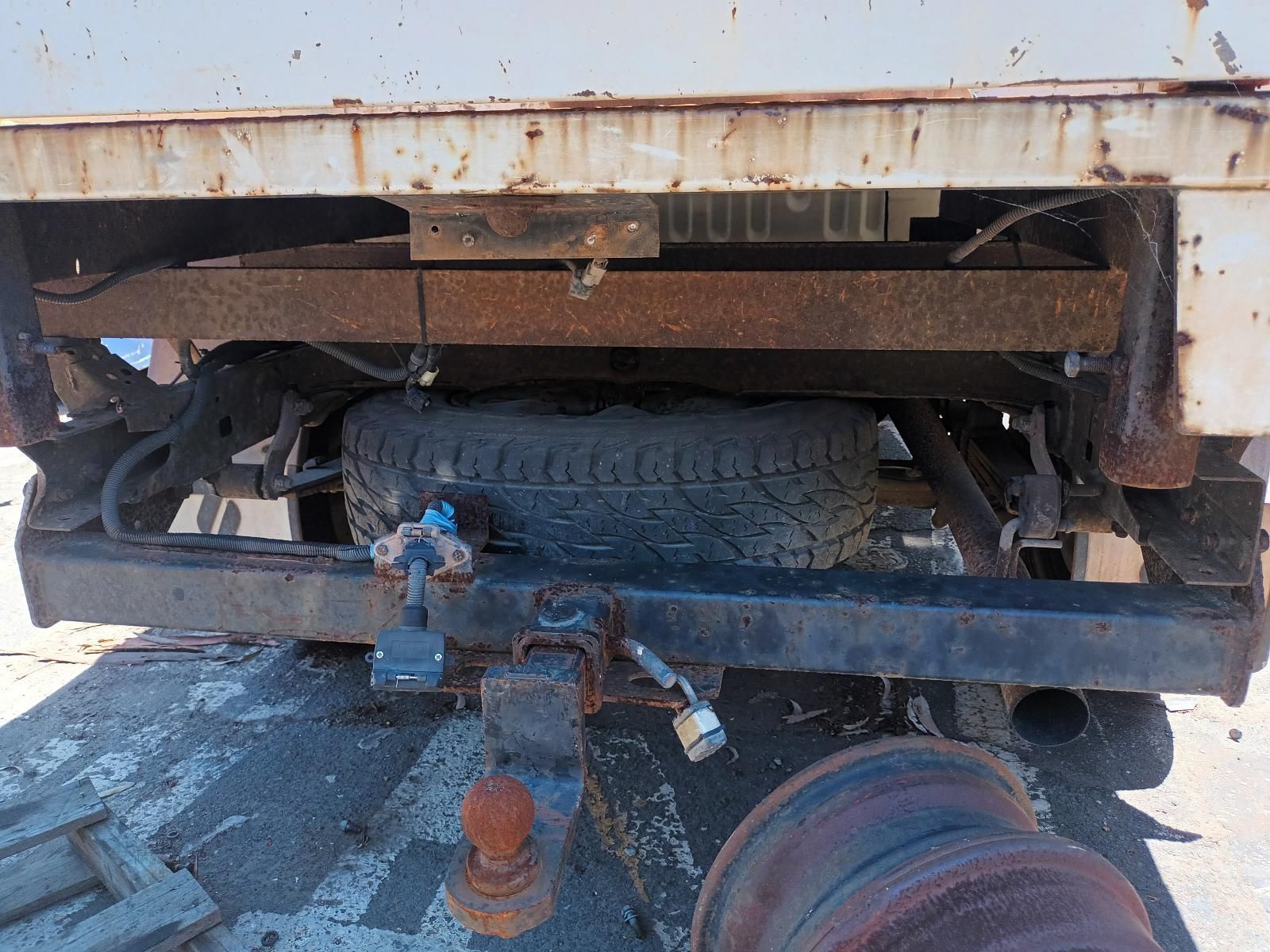 A Rusty Truck with a Trailer Attached to It is Parked on the Side of the Road — South West 4WD Wreckers in Harristown, QLD