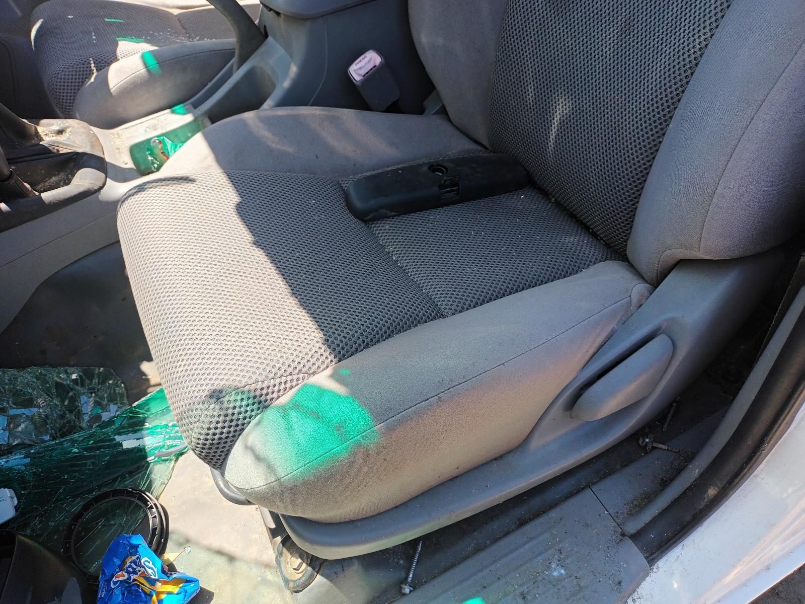 A Car Seat with a Bottle of Soda on It — South West 4WD Wreckers in Harristown, QLD