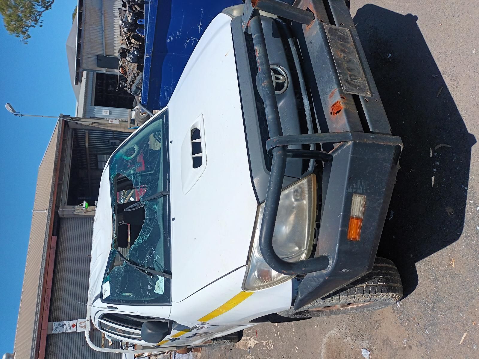 A White Truck with a Broken Windshield is Parked on the Side of the Road — South West 4WD Wreckers in Harristown, QLD