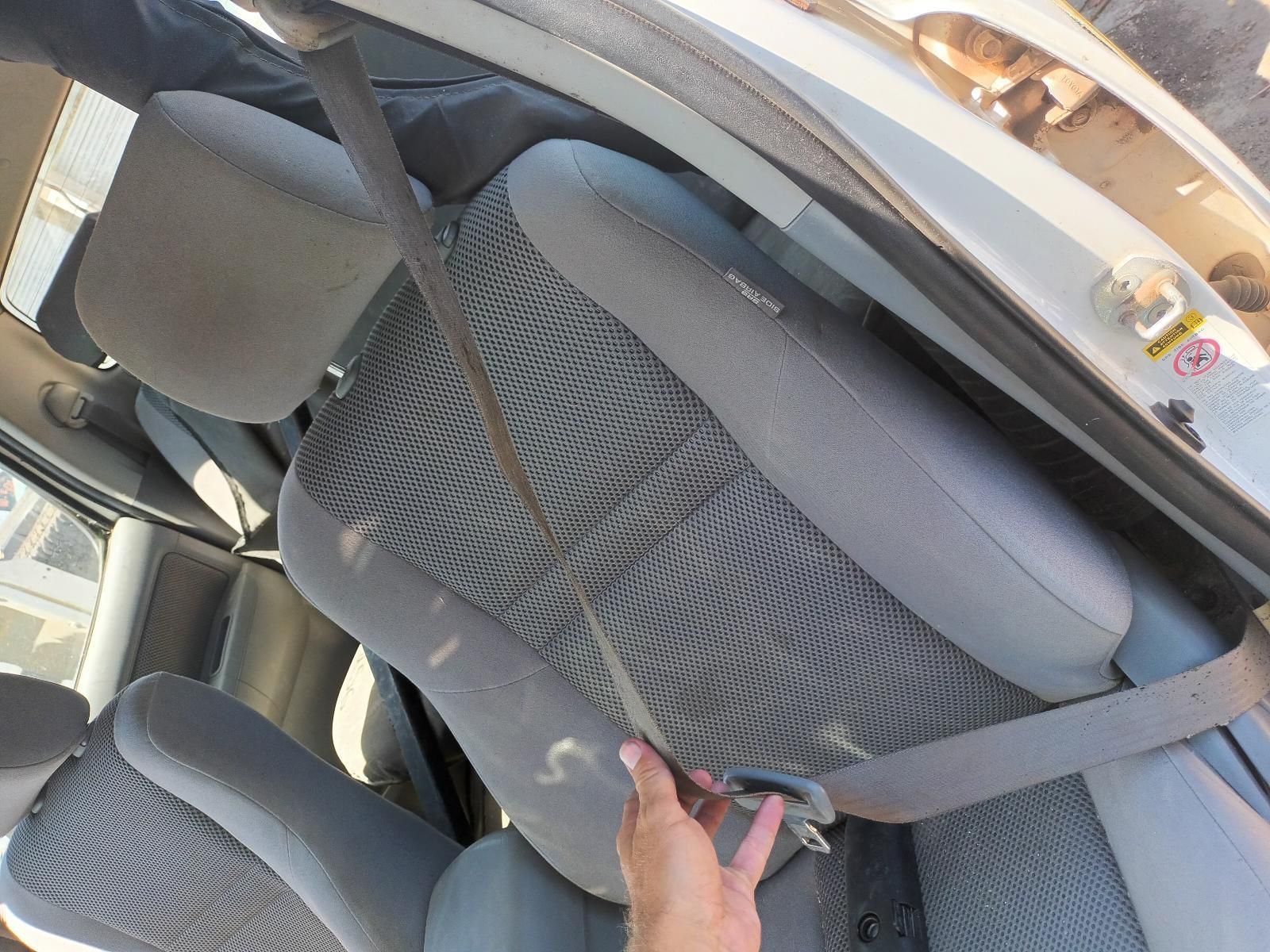 A Person is Putting on a Seat Belt in a Car — South West 4WD Wreckers in Harristown, QLD