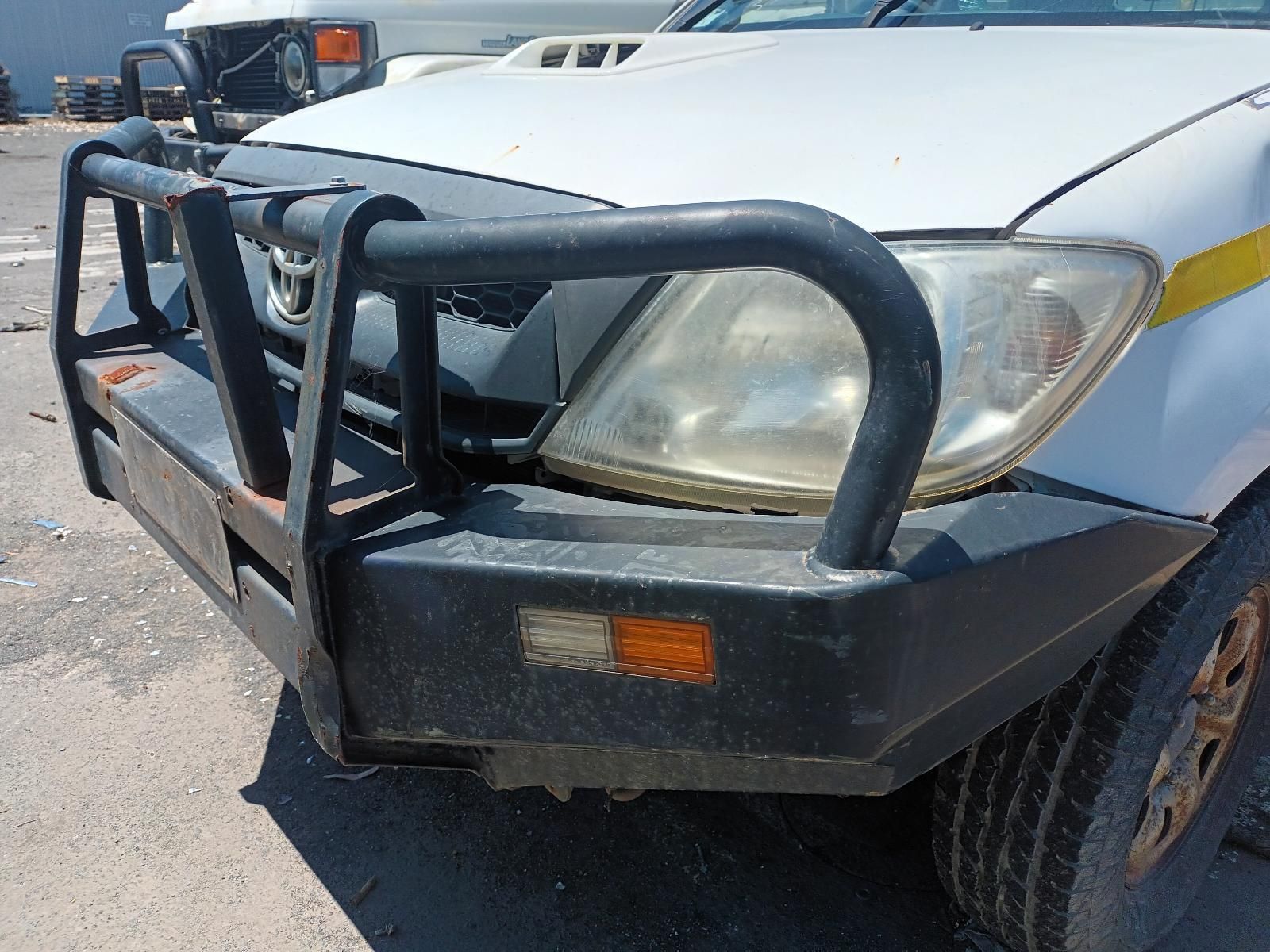 A White Truck with a Black Bumper is Parked in a Parking Lot — South West 4WD Wreckers in Harristown, QLD