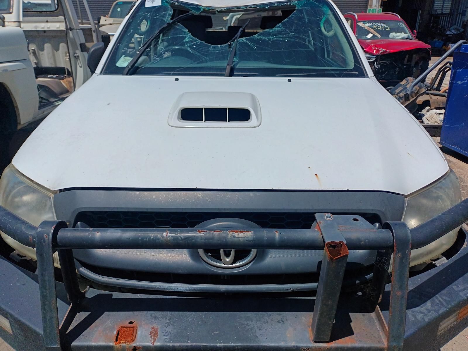 A White Truck with a Broken Windshield is Parked in a Lot — South West 4WD Wreckers in Harristown, QLD
