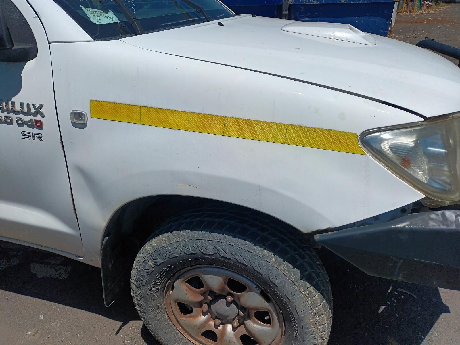 A White Hilux Truck is Parked on the Side of the Road — South West 4WD Wreckers in Harristown, QLD