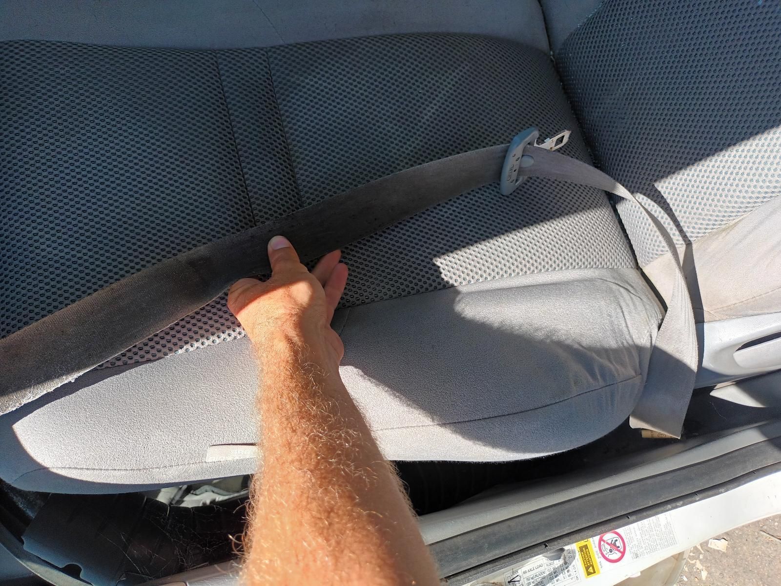 A Person is Putting on a Seat Belt in a Car — South West 4WD Wreckers in Harristown, QLD