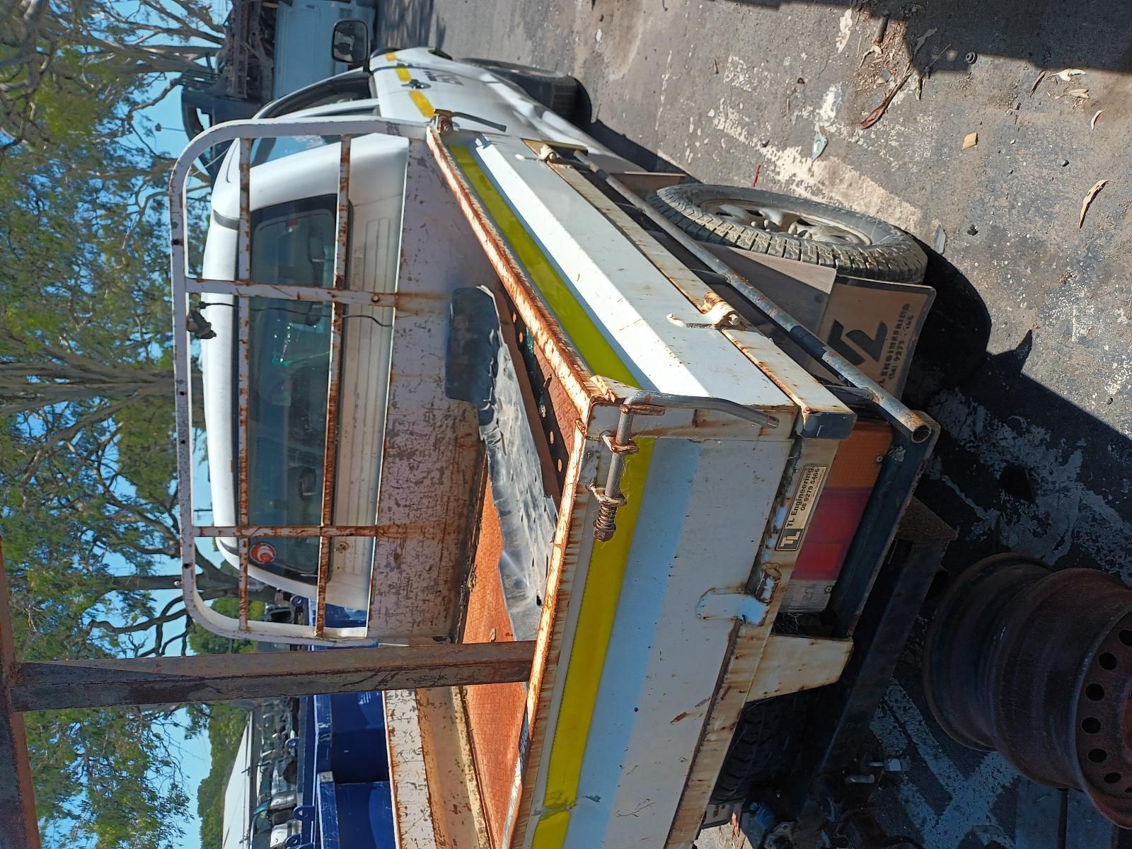 A White Truck with a Yellow Stripe on the Bed — South West 4WD Wreckers in Harristown, QLD