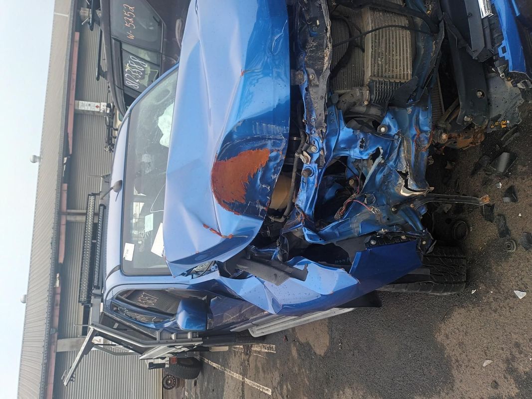 A Blue Car with a Damaged Front End is Sitting on the Ground — South West 4WD Wreckers In Brisbane, QLD