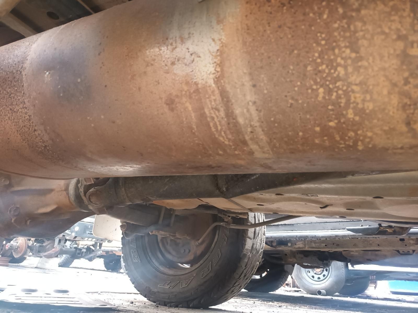 A Close Up of a Rusty Exhaust Pipe on the Underside of a Car — South West 4WD Wreckers In Brisbane, QLD