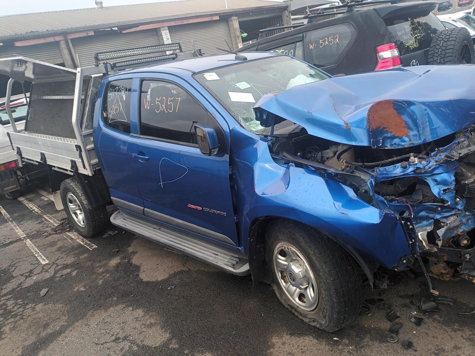 A Blue Truck with a Damaged Hood is Parked in a Parking Lot — South West 4WD Wreckers In Brisbane, QLD